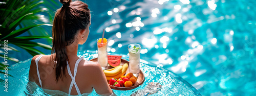 woman in the pool with fruit and cocktail. Selective focus.