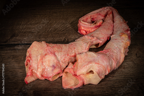 Fresh pork trachea on a wooden background, side view