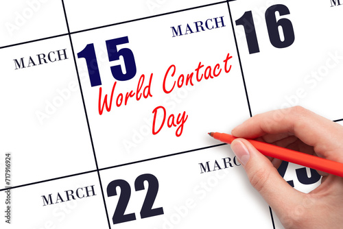 March 15. Hand writing text World Contact Day on calendar date. Save the date.