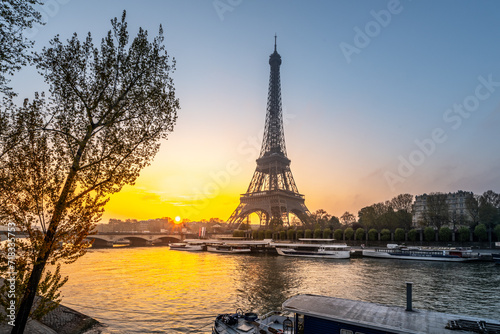 Eiffel Tower, French: Tour Eiffel, silhouette at sunrise time on sunny day. View from Seine River. Paris, France