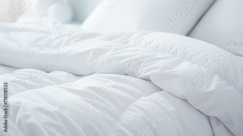 A cozy bed with snow-white linens in a bright white bedroom.