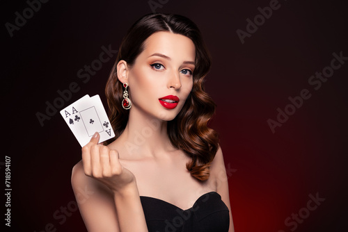 Photo of classy lady professional poker player in night club hold cards over dark background