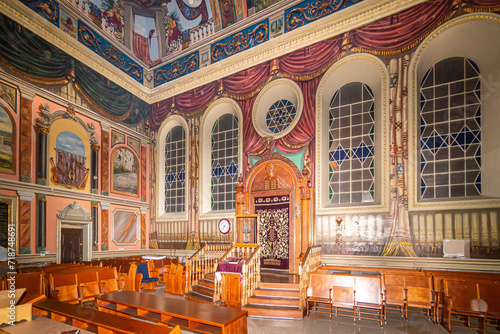 Lviv, Ukraine - March 02 2022: Bright shot of interior of historic Jewish Synagogue or with altar, arched windows and chandelier in Lviv