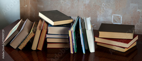 The books are stacked and placed one after another on the table. Concept for education, science, libraries.