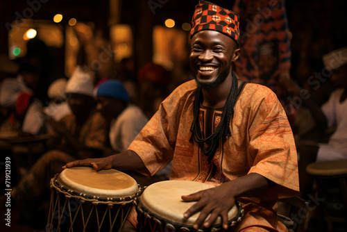 An African male drummer, adorned in colorful attire, skillfully plays the drum