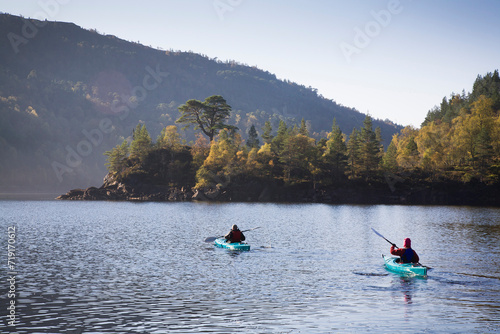 People kayaking in Scotland in Autumn. Glen Affric, Scotland, UK