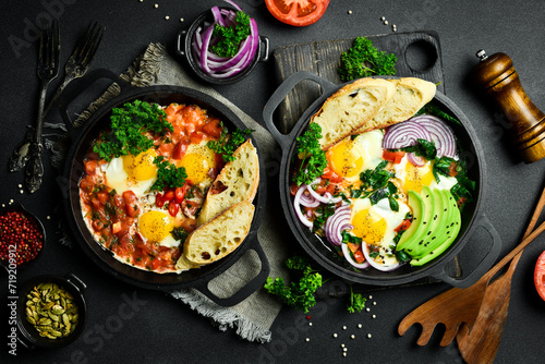 Fried eggs with vegetables: tomatoes, paprika, peppers, onions. Vegetable Shakshuka in a pan. Top view. Free space for your text.