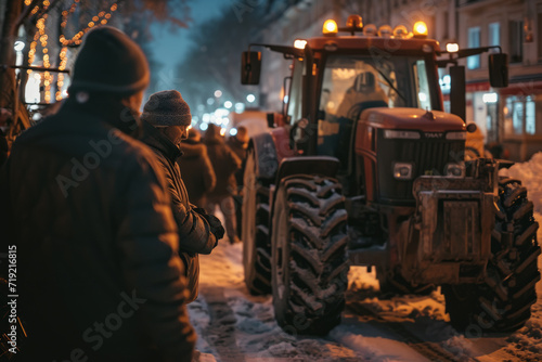 Farmers and workers protest rally and strike in city. People standing next to tractors and protesting against tax increases, changes in law, abolition of benefits on demonstration meeting in street