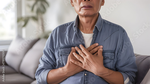 Asian senior man with chest pain. Heart attack patient.