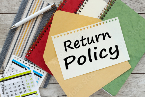 RETURN policy. Close-up of the workplace. Business concept. green and red notepad on the work desk. text on page on envelope