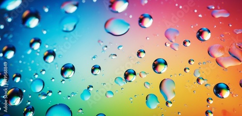 A panoramic abstract background of dew drops on glass, with light creating a stunning spectrum of colors in each droplet