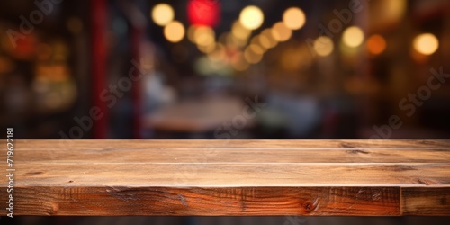 Product display on empty wooden table or counter in a cafeteria, bar, or coffeeshop backdrop.