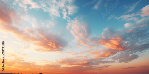 A beautiful sky with blue orange yellow and pink wispy clouds Orange Sky at Dawn Day Summer sunrise blue sky panorama with fleece clouds morning good weather background.