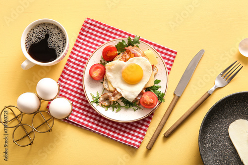 Composition with tasty fried egg, toast, tomatoes and cup of coffee on beige background