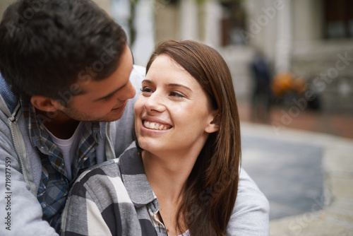 Love, eye contact and happy couple hug together, relax and enjoy outdoor date with care, support and romance. Wellness, happiness and face of boyfriend, girlfriend or people smile for relationship