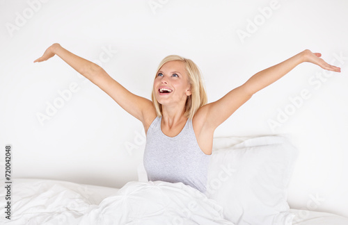 Morning stretching, bedroom and wake up with woman, relax after sleeping or resting. Blanket, peace and comfort of happy person stretch after sleep feeling fresh, awake or joyful with girl or home