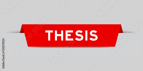 Red color inserted label with word thesis on gray background