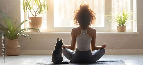 woman doing yoga with a cat