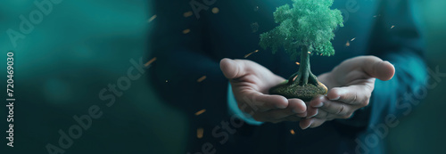 Businessman holding a small tree. New strategies to save our planet earth. Enhance successful global awareness.