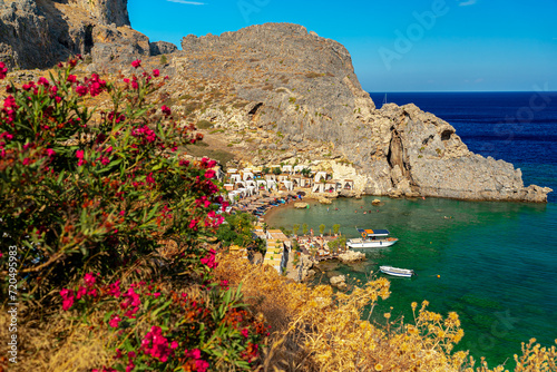 The Acropolis of Lindos and the beach in St. Paul's Bay in Rhodes.