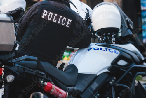 Hellenic Police, Greek police squad on duty riding bike and motorcycle, maintain public order in the streets of Athens, Attica, Greece, group of policemen with "Greek Police" logo emblem on uniform