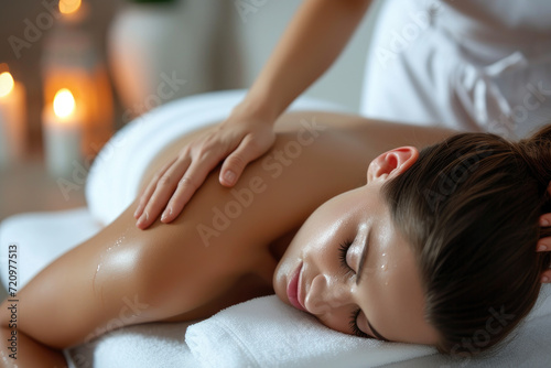 Beautiful young woman received a back massage on a spa bed