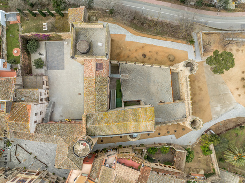 Aerial view of Calonge town medieval castle with inner garrison courtyard surrounded by walls with crenallations and quare old tower, residential palace. Venue for music festival in Catalonia Spain