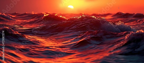 Sunset's dramatic waves in the red ocean, with dark water.
