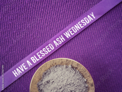 Christianity concept about Ash Wednesday, Good Friday, Lent Season and Holy Week. HAVE A BLESSED ASH WEDNESDAY written on a purple ribbon. With blurred style background.