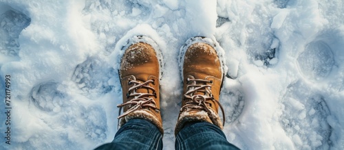 Winter boots for women, viewed from above in a snowdrift.