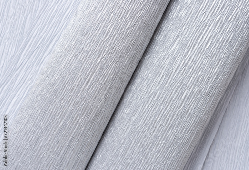 metallic silver crepe paper sheets folded or curled and photographed top-down under natural light