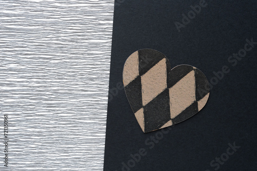 silver crepe paper and machine-cut decorative scrapbooking paper heart with diamantine patterns on black