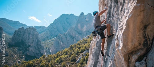 young man doing rock climbing in the mountains