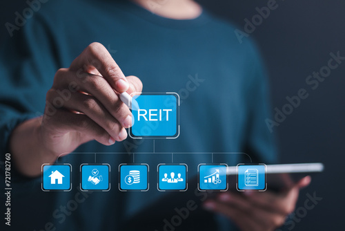 Reit, Real estate investment trust concept, Businessman use tablet with virtual reit icons for real estate management that generates continuous income.