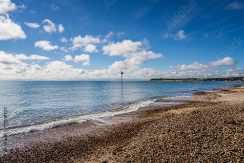 View of the coastline in Christchurch Bay and the houses on Mudeford Sandbank in Mudeford Quay, Dorset, England, UK