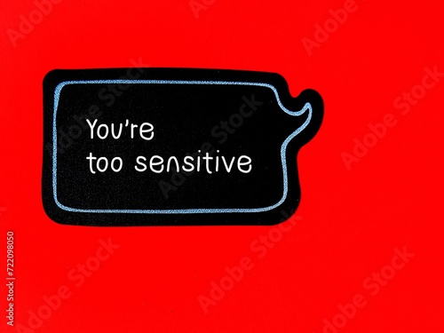 Speech sticker on red background with handwriting YOU ARE TOO SENSITIVE - gaslighting way to accuse or emotional abuse others to question their beliefs or doubt their perception and become distressed