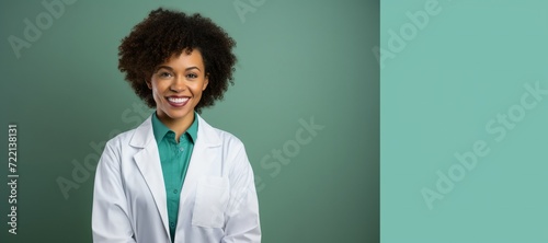 Modern Medical Education Concept. Portrait Of Smiling Black Female Doctor In White Coat Posing Over green Background, Panorama, place for text
