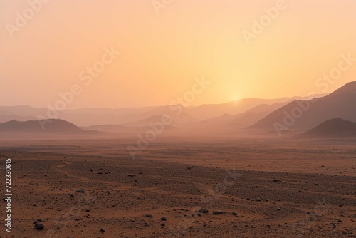 Safari and travel to Africa, extreme adventures or science expedition in a stone desert. Sahara desert at sunrise, mountain landscape with dust on skyline, hills and traces of the off-road car