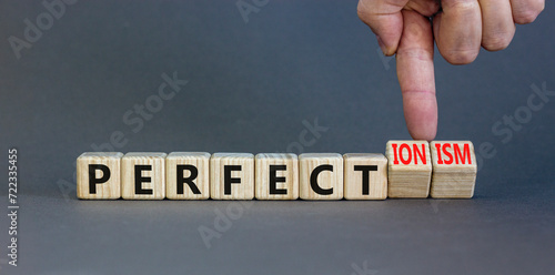 Perfectionism symbol. Concept words Perfect or Perfectionism beautiful wooden blocks. Beautiful grey table grey background. Businessman hand. Business and perfectionism or perfect concept. Copy space.