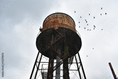 Creepy water tower outside abandoned factory 