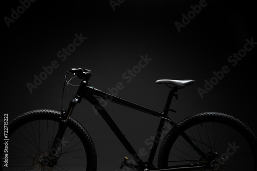 Black mountain bicycle on black background