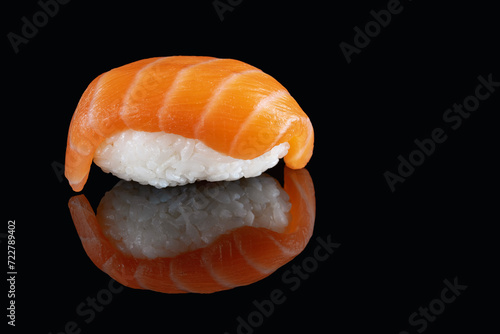 Composition of fresh salmon sashimi sushi isolated on a black background with reflect.A healthy delicacy.Copy space. Place for your text.Billboard.