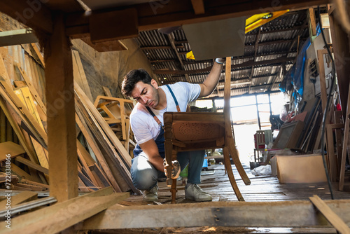 Carpenter man doing diy chair in vintage carpentry wood working shop