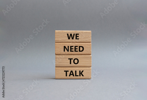 We need to talk symbol. Concept words We need to talk on wooden blocks. Beautiful grey background. Business and We need to talk concept. Copy space.