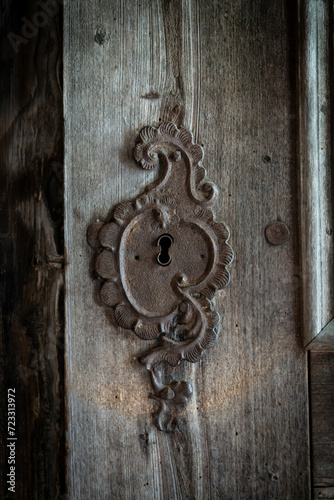 Iron rusty decorative keyhole overlay on old wooden gates of Biertan fortified saxon church, Unesco World Heritage site, in Biertan village, Transylvania, Romania, Europe.