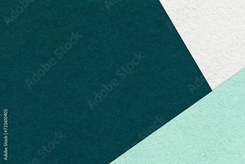 Texture of craft dark emerald color paper background with white, green and mint border. Vintage abstract cardboard.