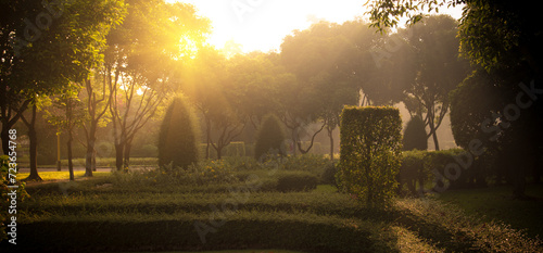 Banner Paris green park Fountain in garden sunlight on sunrise. Panorama Paris Garden with fountain and green bush in morning. Blurred background nature park fountain scenic with copy space