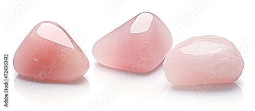 Three tumbled rose quartz stones. Semi-precious rose quartz crystals are a love talisman
