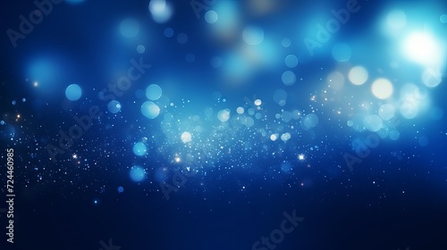 Blue glowing particles on dark background with bokeh effect