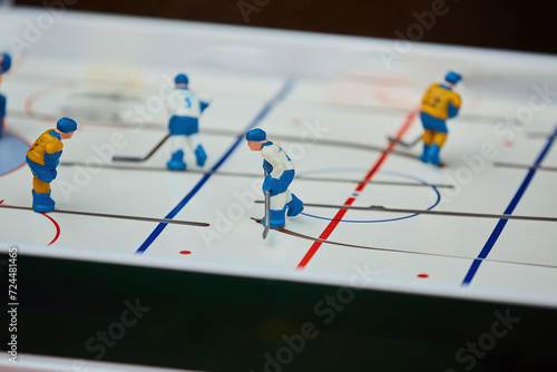 A board game of hockey. A miniature field. A game for two.